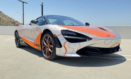 Vehicle wrap design in practice: front three-quarter view of the McLaren 720S matte PPF wrap with orange contour graphics by 2wrap.com